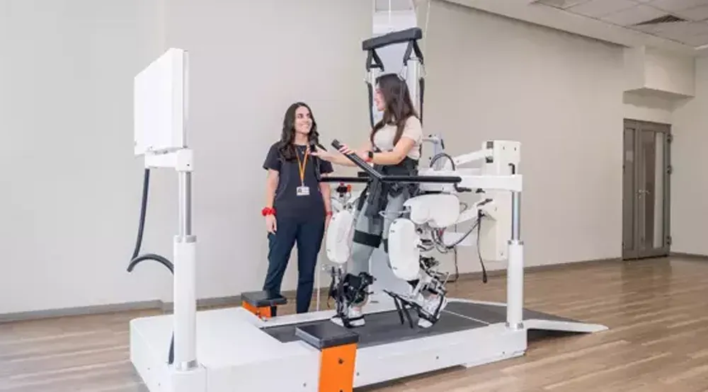 Robotic gait training with a therapist